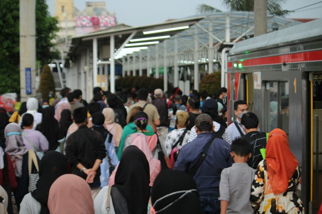 a crowd of people waiting for a train