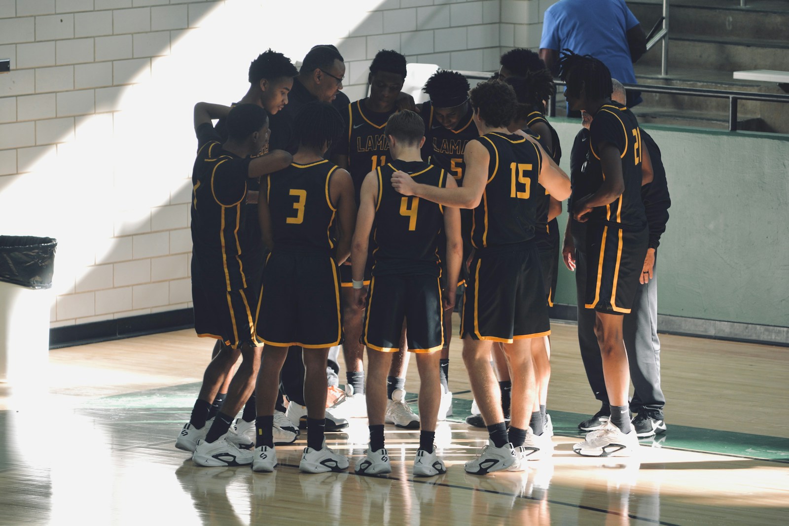 A group of young men standing on top of a basketball court