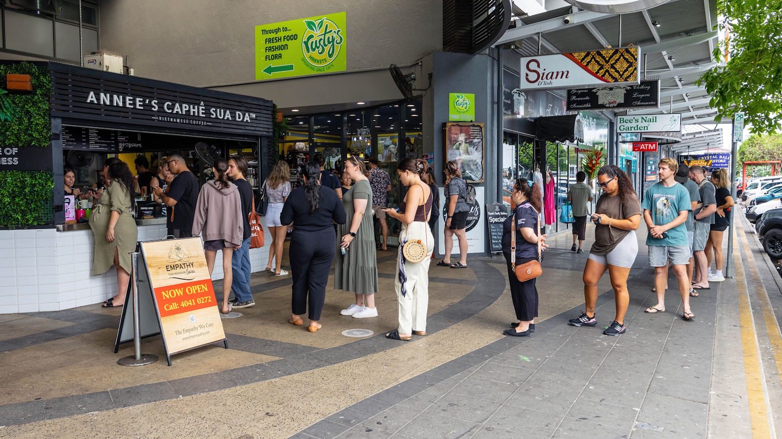 a group of people standing outside of a store